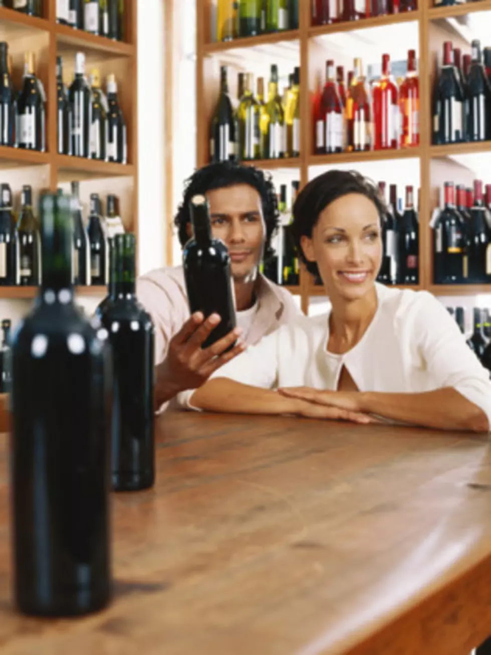 Young couple choosing bottles of wine